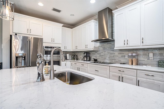 2515 63rd Ter E, Ellenton, FL 34222 - kitchen with wall chimney exhaust hood, appliances with stainless steel finishes, recessed lighting, white cabinetry, and tasteful backsplash