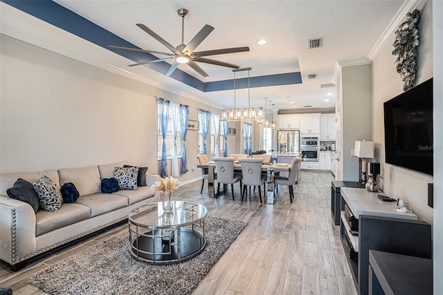 2515 63rd Ter E, Ellenton, FL 34222 - living room with crown molding, a tray ceiling, a ceiling fan, light wood-type flooring, and recessed lighting