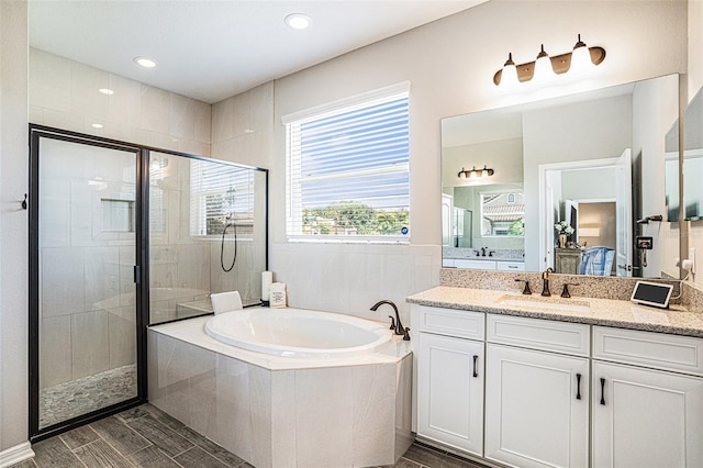 2515 63rd Ter E, Ellenton, FL 34222 - ensuite bathroom with a bath, a shower stall, vanity, and wood finish floors