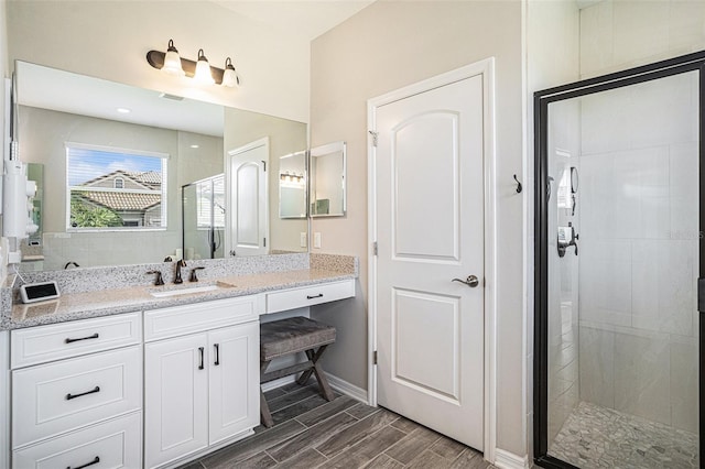 2515 63rd Ter E, Ellenton, FL 34222 - full bath with a shower stall, wood finish floors, vanity, and baseboards