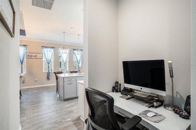 2515 63rd Ter E, Ellenton, FL 34222 - office area featuring light wood-type flooring, crown molding, baseboards, and a sink