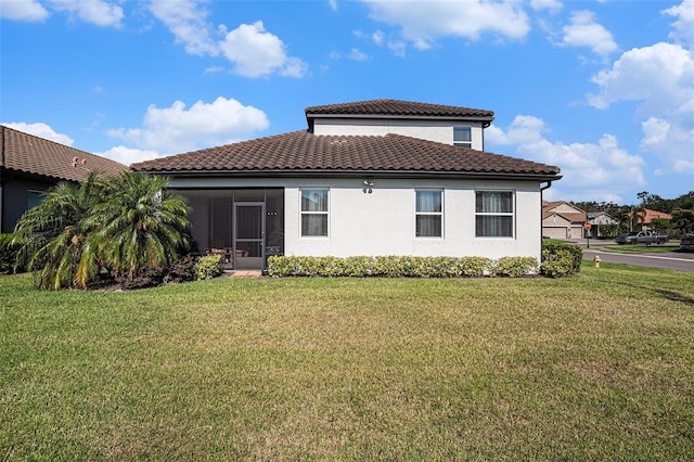 2515 63rd Ter E, Ellenton, FL 34222 - rear view of house featuring a lawn, stucco siding, a tile roof, and a sunroom