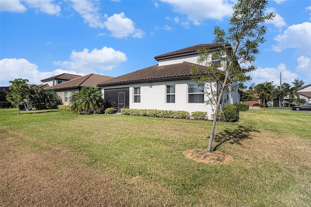 2515 63rd Ter E, Ellenton, FL 34222 - back of house featuring a tile roof, a lawn, and stucco siding