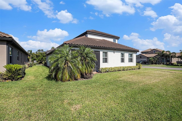 2515 63rd Ter E, Ellenton, FL 34222 - view of side of home with a tile roof, a lawn, and stucco siding