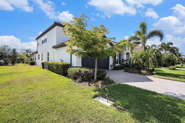 2515 63rd Ter E, Ellenton, FL 34222 - view of home's exterior with driveway, a lawn, a garage, and stucco siding