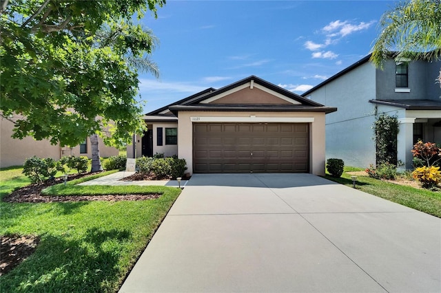 11121 Hudson Hills Ln, Riverview, FL 33579 - ranch-style house with stucco siding, concrete driveway, a garage, and a front yard