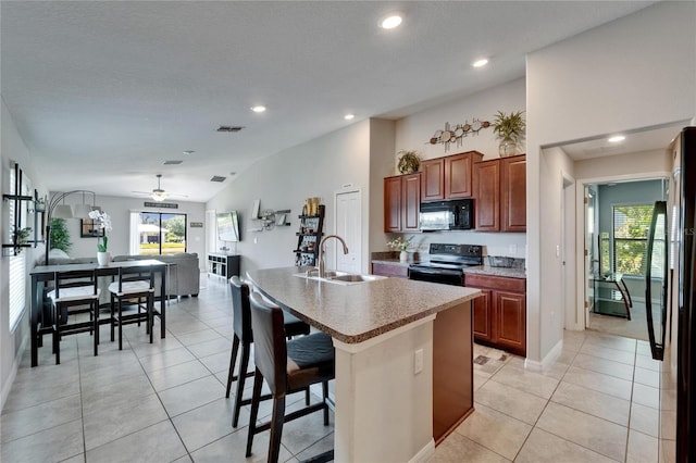 11121 Hudson Hills Ln, Riverview, FL 33579 - kitchen featuring black appliances, a sink, vaulted ceiling, a kitchen breakfast bar, and a ceiling fan