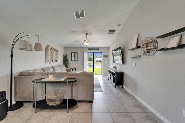 11121 Hudson Hills Ln, Riverview, FL 33579 - living room with a ceiling fan, light tile patterned floors, baseboards, and lofted ceiling