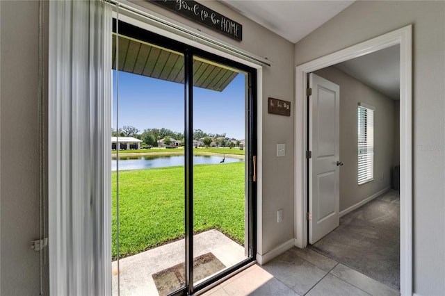 11121 Hudson Hills Ln, Riverview, FL 33579 - entryway featuring a water view, baseboards, and tile patterned flooring