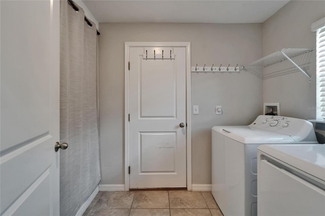 11121 Hudson Hills Ln, Riverview, FL 33579 - laundry area with washing machine and clothes dryer, light tile patterned floors, and baseboards