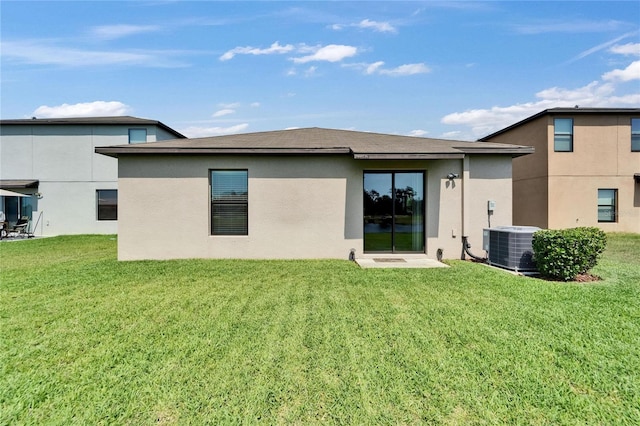 11121 Hudson Hills Ln, Riverview, FL 33579 - back of house with stucco siding, a yard, and central air condition unit
