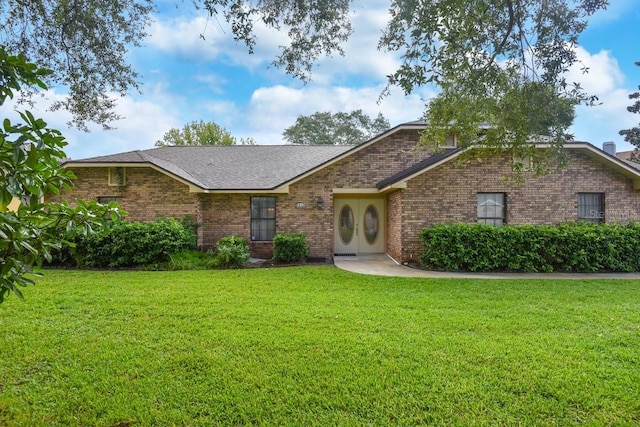 24 Lake Vista Way, Ormond Beach, FL 32174 - view of front of home featuring a front yard, brick siding, and a shingled roof