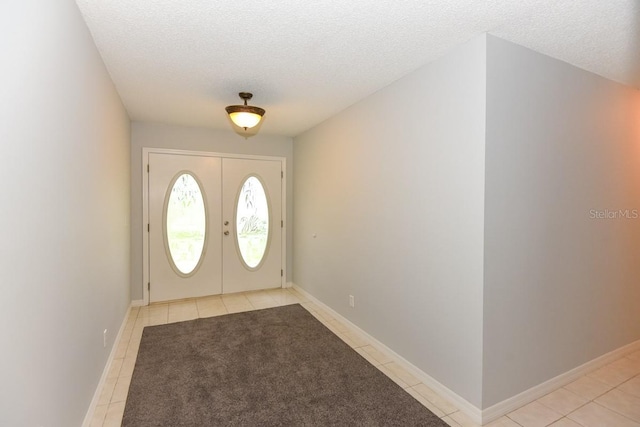 24 Lake Vista Way, Ormond Beach, FL 32174 - foyer entrance with light tile patterned floors, a textured ceiling, french doors, and baseboards