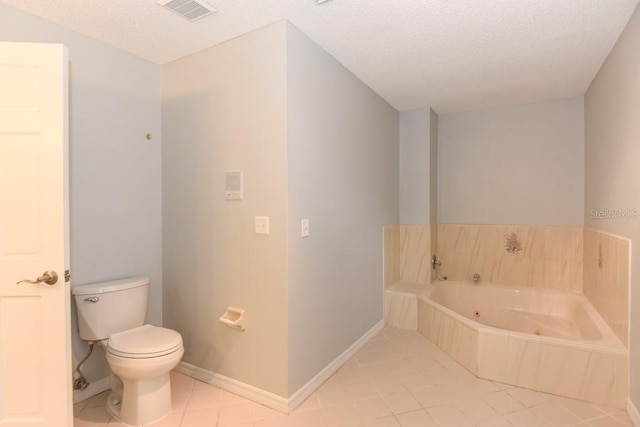 24 Lake Vista Way, Ormond Beach, FL 32174 - bathroom with toilet, tile patterned floors, a whirlpool tub, baseboards, and a textured ceiling