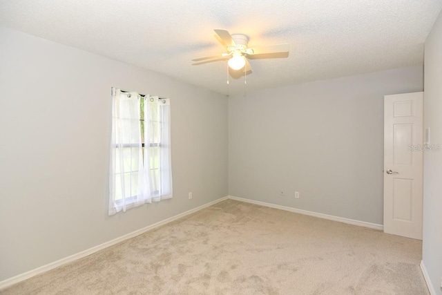 24 Lake Vista Way, Ormond Beach, FL 32174 - spare room featuring light colored carpet, a ceiling fan, baseboards, and a textured ceiling