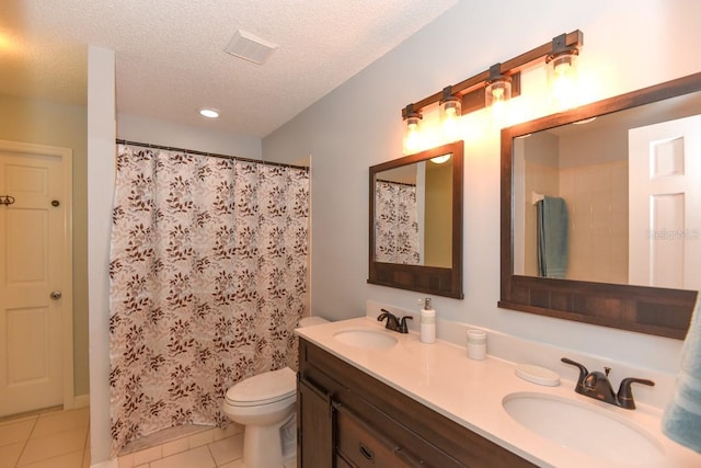 24 Lake Vista Way, Ormond Beach, FL 32174 - full bathroom with tile patterned flooring, a textured ceiling, double vanity, toilet, and a shower with curtain