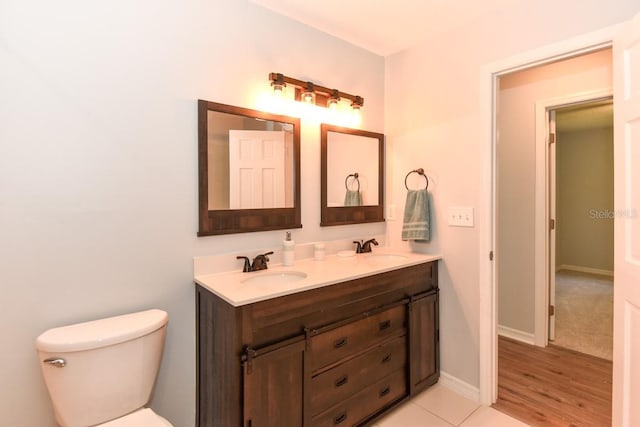 24 Lake Vista Way, Ormond Beach, FL 32174 - bathroom featuring toilet, double vanity, and baseboards