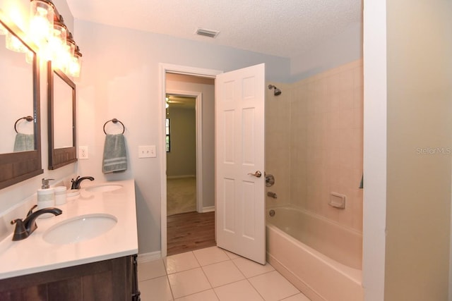 24 Lake Vista Way, Ormond Beach, FL 32174 - full bath with tile patterned floors, shower / washtub combination, a textured ceiling, and double vanity
