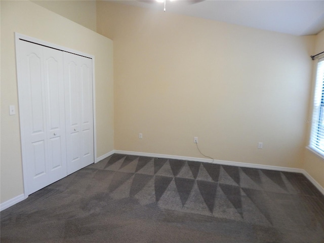 16618 Kingletside Ct, Lithia, FL 33547 - unfurnished bedroom with dark carpet, a closet, and baseboards