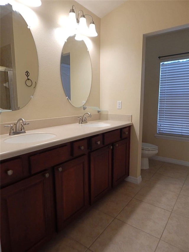 16618 Kingletside Ct, Lithia, FL 33547 - full bathroom featuring tile patterned flooring, double vanity, toilet, and a shower with door