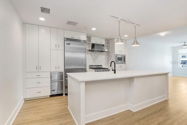 1120 E Kennedy Blvd Unit 1127, Tampa, FL 33602 - kitchen featuring built in appliances, under cabinet range hood, light wood-style floors, white cabinetry, and recessed lighting