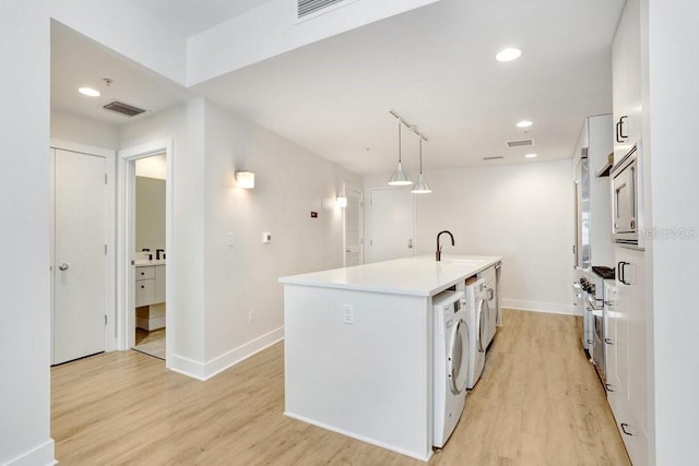 1120 E Kennedy Blvd Unit 1127, Tampa, FL 33602 - laundry room featuring light wood-type flooring, baseboards, and recessed lighting