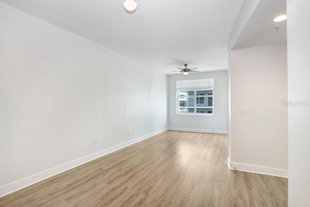 1120 E Kennedy Blvd Unit 1127, Tampa, FL 33602 - spare room featuring light wood finished floors, baseboards, and ceiling fan
