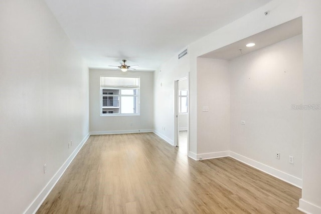 1120 E Kennedy Blvd Unit 1127, Tampa, FL 33602 - empty room featuring light wood finished floors, ceiling fan, baseboards, and a pendent fire sprinkler