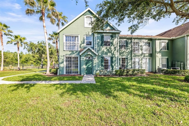 9416 Lake Chase Island Way Unit 9416, Tampa, FL 33626 - view of front facade featuring stucco siding and a front lawn