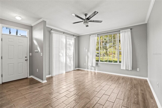 9416 Lake Chase Island Way Unit 9416, Tampa, FL 33626 - entryway featuring wood finished floors, ceiling fan, baseboards, ornamental molding, and a textured ceiling
