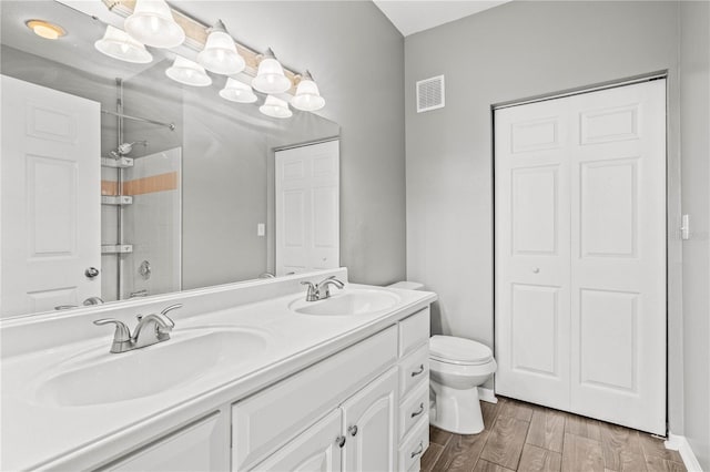 9416 Lake Chase Island Way Unit 9416, Tampa, FL 33626 - full bath featuring an enclosed shower, double vanity, toilet, and wood finished floors