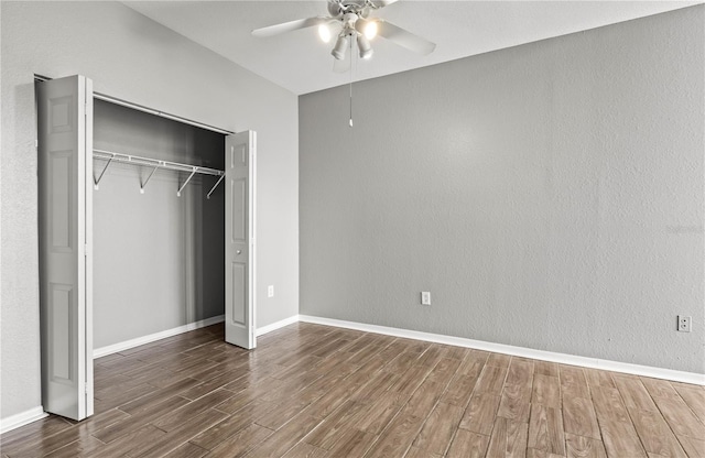 9416 Lake Chase Island Way Unit 9416, Tampa, FL 33626 - unfurnished bedroom featuring wood finished floors, a closet, baseboards, and a ceiling fan
