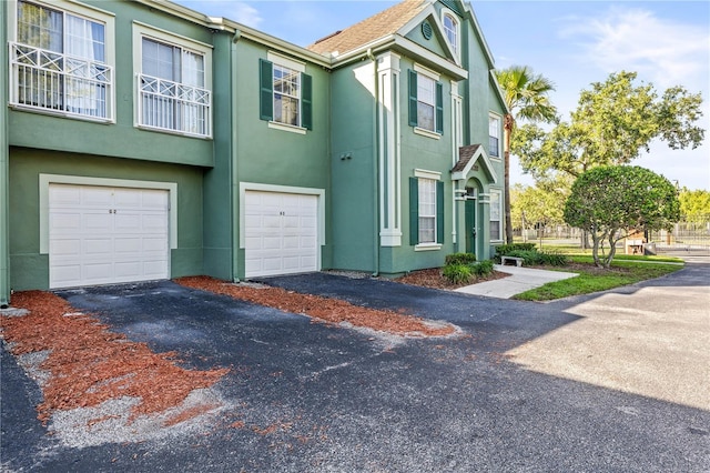 9416 Lake Chase Island Way Unit 9416, Tampa, FL 33626 - view of front facade with a garage, stucco siding, and driveway