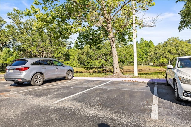 9416 Lake Chase Island Way Unit 9416, Tampa, FL 33626 - uncovered parking lot with view of scattered trees