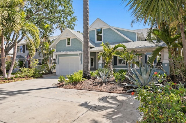 2903 Pass A Grille Way, St Pete Beach, FL 33706 - view of front of house featuring a garage, driveway, and roof with shingles