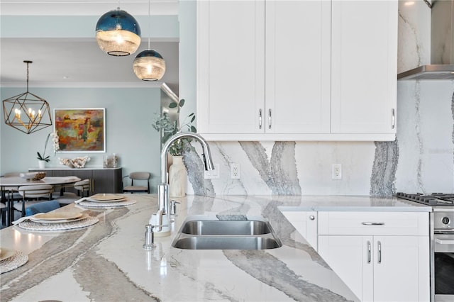 2903 Pass A Grille Way, St Pete Beach, FL 33706 - kitchen featuring a sink, gas stove, wall chimney exhaust hood, backsplash, and a chandelier
