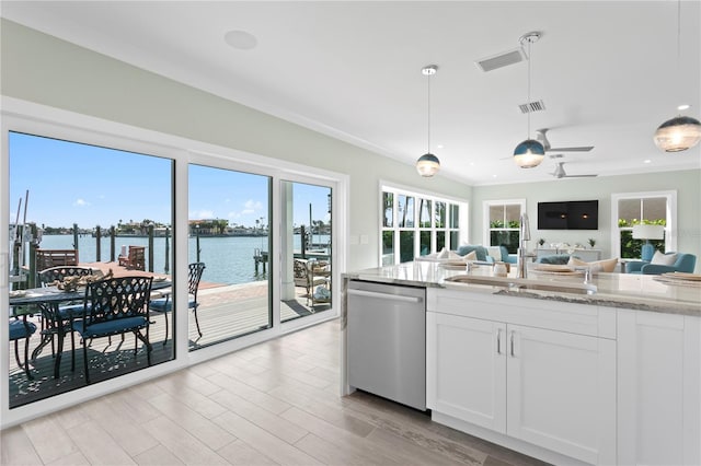 2903 Pass A Grille Way, St Pete Beach, FL 33706 - kitchen with stainless steel dishwasher, a sink, open floor plan, light stone countertops, and white cabinetry