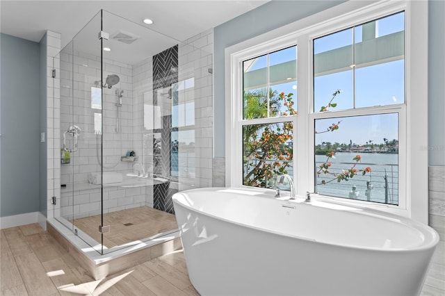 2903 Pass A Grille Way, St Pete Beach, FL 33706 - bathroom featuring a shower stall, wood finished floors, a soaking tub, and recessed lighting