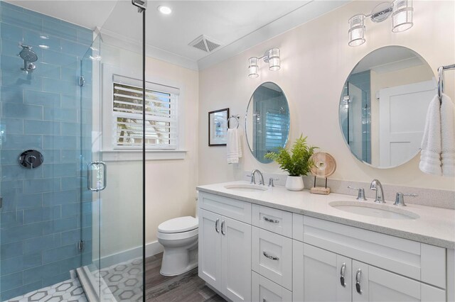 2903 Pass A Grille Way, St Pete Beach, FL 33706 - full bath featuring a stall shower, double vanity, toilet, and wood finished floors