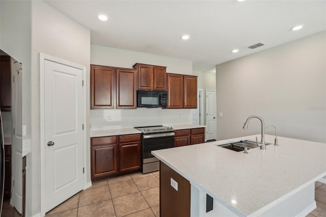 10326 Boggy Moss Dr, Riverview, FL 33578 - kitchen with black microwave, a sink, stainless steel range with electric stovetop, an island with sink, and light tile patterned floors