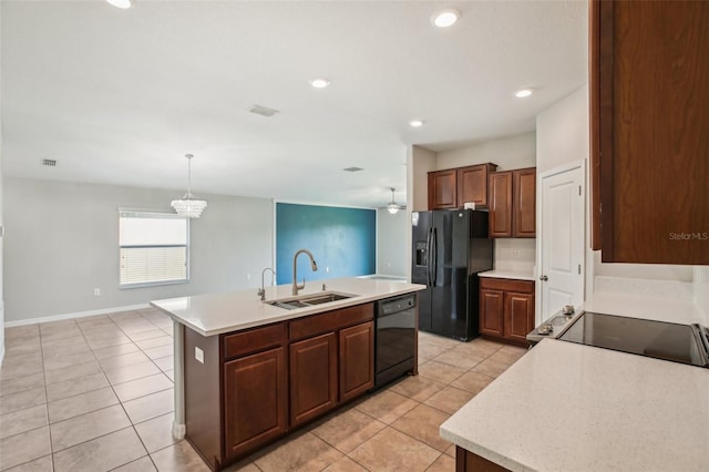 10326 Boggy Moss Dr, Riverview, FL 33578 - kitchen featuring a sink, black appliances, light countertops, a center island with sink, and light tile patterned floors