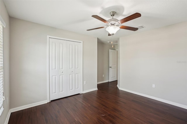 10326 Boggy Moss Dr, Riverview, FL 33578 - unfurnished bedroom with baseboards, dark wood-type flooring, a closet, and a ceiling fan