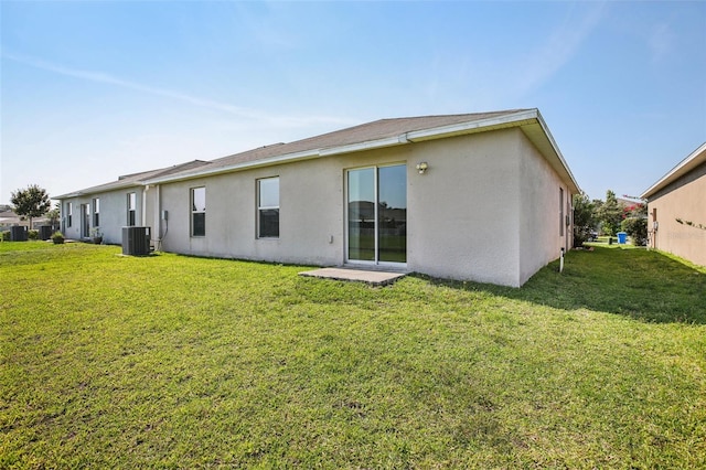10326 Boggy Moss Dr, Riverview, FL 33578 - back of property with central air condition unit, stucco siding, and a lawn