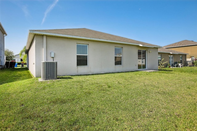 10326 Boggy Moss Dr, Riverview, FL 33578 - rear view of house featuring central air condition unit, stucco siding, and a lawn