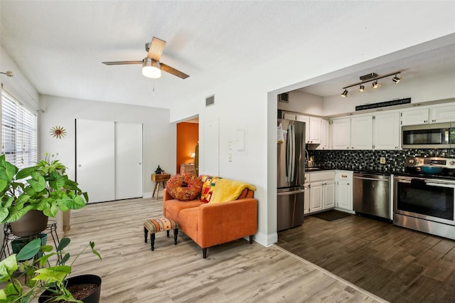 2416 World Parkway Blvd Unit 26, Clearwater, FL 33763 - living area with dark wood-style floors and ceiling fan
