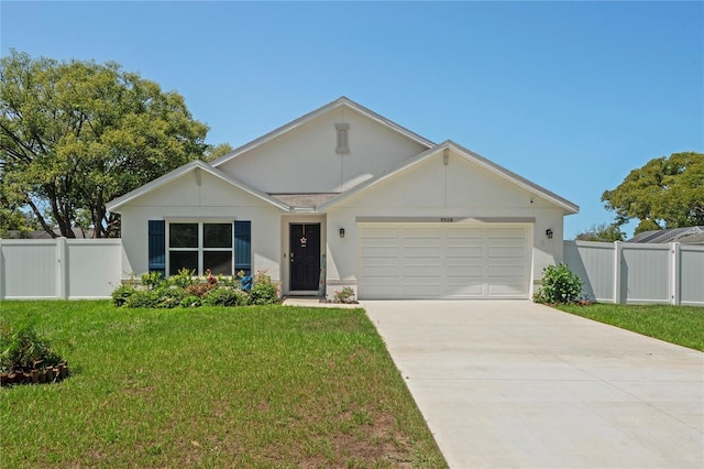 8508 Bay Dr, Spring Hill, FL 34606 - view of front of home with driveway, an attached garage, and stucco siding