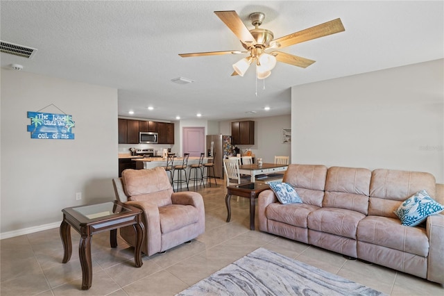 8508 Bay Dr, Spring Hill, FL 34606 - living room with light tile patterned floors, a ceiling fan, recessed lighting, and baseboards