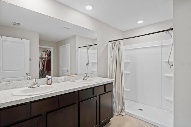 8508 Bay Dr, Spring Hill, FL 34606 - full bathroom featuring a stall shower, a spacious closet, double vanity, and tile patterned floors