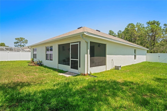 8508 Bay Dr, Spring Hill, FL 34606 - rear view of property with a sunroom and stucco siding