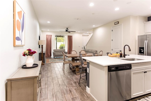 14245 Damselfly Dr, Tampa, FL 33625 - kitchen with stainless steel appliances, a sink, light wood finished floors, light countertops, and recessed lighting